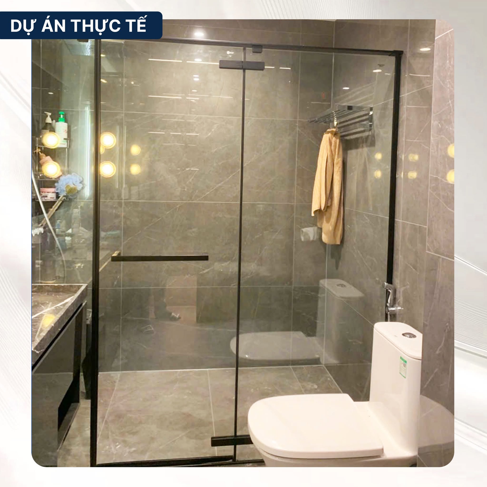 Phòng tắm kính Blue Sanitary khung đen trong không gian ốp đá xám
